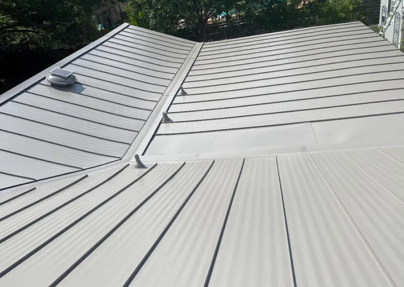 Solar attic fan installed on a metal roof for Roof Ventilation in Mayfair